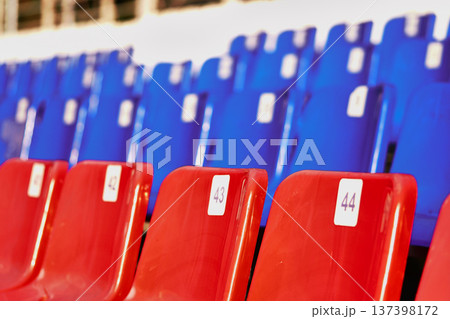 Empty seats in a stadium, close-up. Blue and red seats            137398172