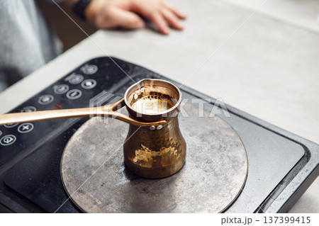 Traditional Turkish Coffee Brewing on Modern Electric Stove, Captured From Above 137399415