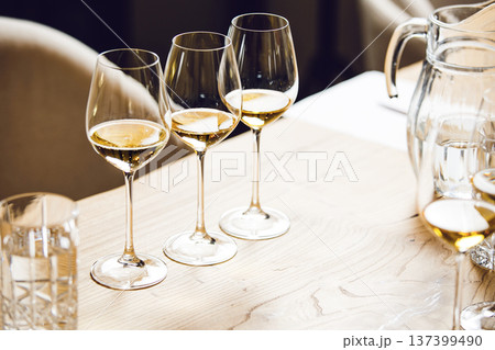 White wines in glasses on table, sommelier tasting preparation. White wines in glasses on table, sommelier tasting preparation. Wine waiter training, winemaking school. White wines in glasses on table, sommelier tasting preparation. White wines in glasses on table, sommelier tasting preparation. Wine waiter training, winemaking school. 137399490