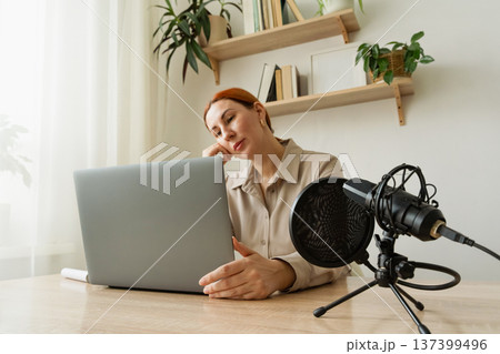 Woman recording podcast at home studio. A popular psychologist blogger on social media holds a video meeting on his channel Woman recording podcast at home studio. A popular psychologist blogger on social media holds a video meeting on his channel 137399496