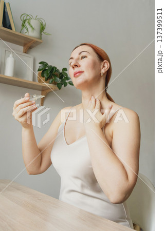 Woman massaging neck for skincare routine 137399511