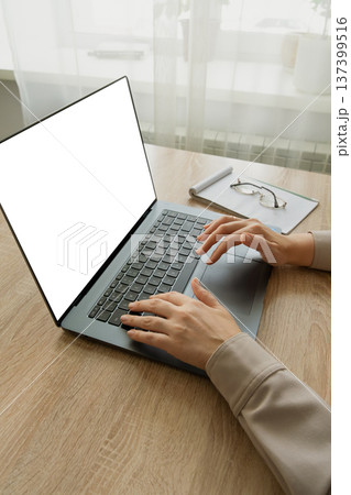 Woman typing on laptop working from home office Woman typing on laptop working from home office 137399516