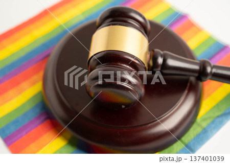 Gavel for judge lawyer on rainbow flag, symbol of LGBT pride month. Gavel for judge lawyer on rainbow flag, symbol of LGBT pride month. 137401039
