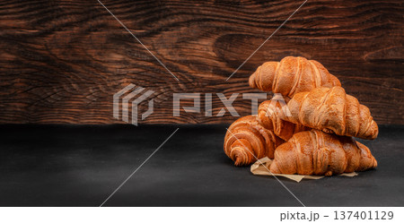 Fresh Croissants Stack on Rustic Wooden Background Fresh Croissants Stack on Rustic Wooden Background 137401129
