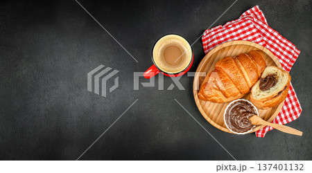 Croissant Breakfast with Coffee and Chocolate Spread on Dark Background 137401132