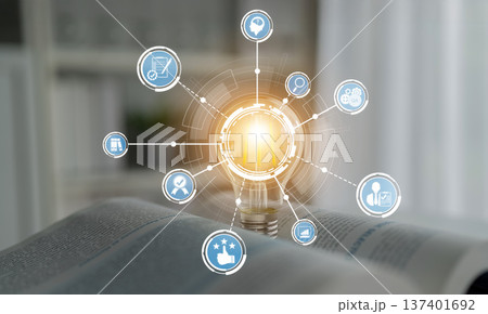 Conceptual digital illustration depicting light bulb with icons representing ideas, knowledge, creativity, and innovation on a blurred background of open book. Crux 137401692