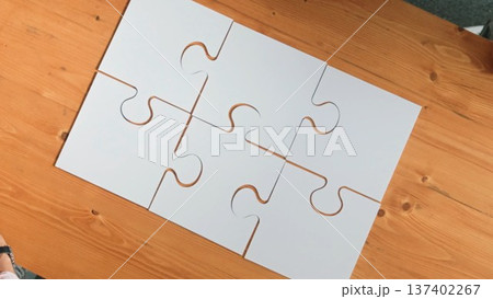 Top down view of business people assemble jigsaw puzzle on table. Convocation. Top down view of business people assemble jigsaw puzzle on table. Convocation. 137402267