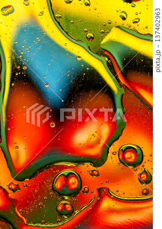 Rainbow oil slick on water surface with intense red and yellow colors 137402963