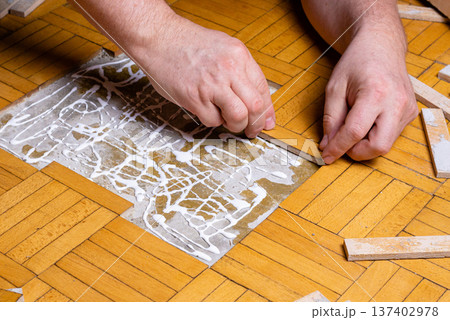 Professional Worker Spreading Glue on Parquet Floor Surface Professional Worker Spreading Glue on Parquet Floor Surface 137402978