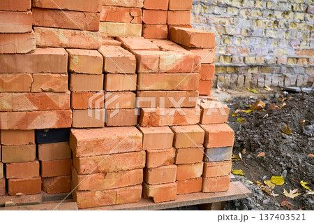 Stacked bricks on a wooden pallet on construction site Stacked bricks on a wooden pallet on construction site 137403521