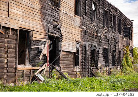 Abandoned log house aftermath showing extensive fire damage and destruction Abandoned log house aftermath showing extensive fire damage and destruction 137404182