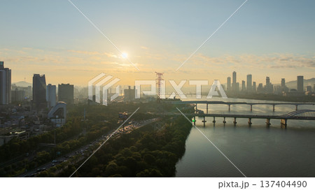 Aerial cinematic sunrise over Seonyudo Park and Hangang River with Yeouido skyline, Seoul. Aerial cinematic sunrise over Seonyudo Park and Hangang River with Yeouido skyline, Seoul. 137404490