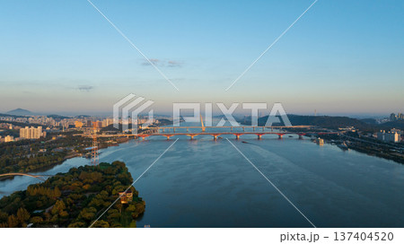 Aerial cinematic sunrise over Seonyudo Park and Hangang River with Yeouido skyline, Seoul. Aerial cinematic sunrise over Seonyudo Park and Hangang River with Yeouido skyline, Seoul. 137404520
