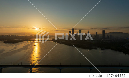Aerial cinematic sunrise over Seonyudo Park and Hangang River with Yeouido skyline, Seoul. Aerial cinematic sunrise over Seonyudo Park and Hangang River with Yeouido skyline, Seoul. 137404521