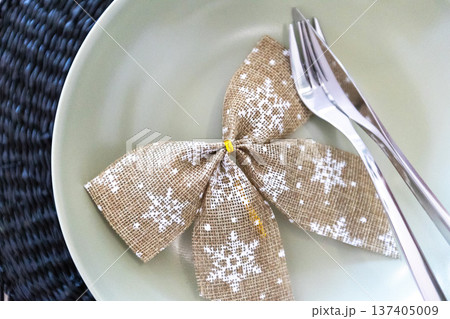 decorative ribbon and cutlery on plate 137405009
