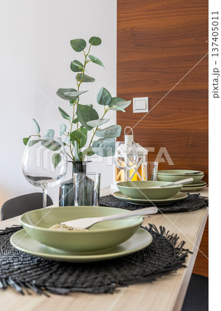 modern dining table setting with eucalyptus 137405011