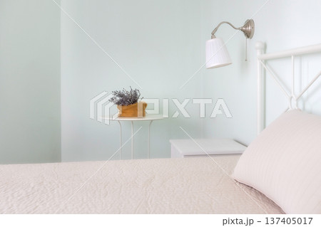 Minimal bedroom, bed, lamp and lavender decor Minimal bedroom, bed, lamp and lavender decor 137405017