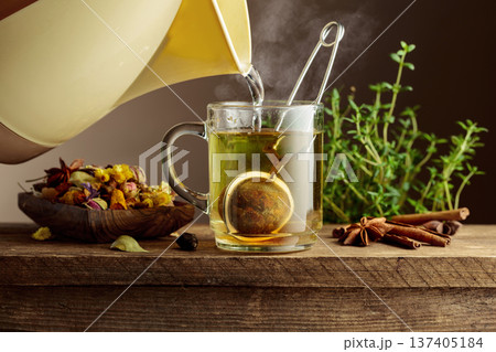 Herbal tea with ingredients on a old wooden table. 137405184