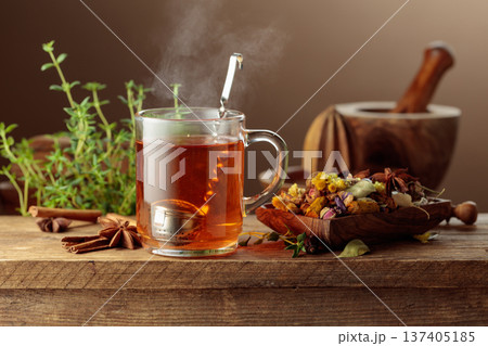 Herbal tea with ingredients on a old wooden table. Herbal tea with ingredients on a old wooden table. 137405185