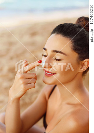 Beautiful Woman Face Portrait Beauty Skin Care Concept. Suncream. Suntan Lotion Beautiful Woman Applying on beautiful on Face. Sunscreen Solar Cream. Sun protection.The Girl Uses Moisturizer Sunblock Beautiful Woman Face Portrait Beauty Skin Care Concept. Suncream. Suntan Lotion Beautiful Woman Applying on beautiful on Face. Sunscreen Solar Cream. Sun protection.The Girl Uses Moisturizer Sunblock 137406216
