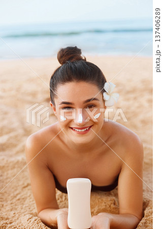 Skin care. Sun protection. Beautiful Woman In Bikini apply sun cream on Face. Woman With Suntan Lotion On Beach. Portrait Of Female Holding Moisturizing Sunblock.The Girl Uses Sunscreen for Her Skin. Skin care. Sun protection. Beautiful Woman In Bikini apply sun cream on Face. Woman With Suntan Lotion On Beach. Portrait Of Female Holding Moisturizing Sunblock.The Girl Uses Sunscreen for Her Skin. 137406289