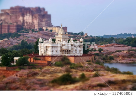 Scenic view of the white marble Jaswant Thada cenotaph in Jodhpur, Rajasthan, surrounded by rocky hills and a tranquil lake at sunset. Scenic view of the white marble Jaswant Thada cenotaph in Jodhpur, Rajasthan, surrounded by rocky hills and a tranquil lake at sunset. 137406808