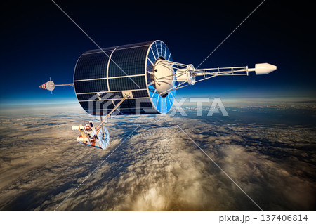Detailed view of a satellite in space, featuring metallic structure, antennas, and large solar panels, orbiting above Earth's blue atmosphere and orange-tinted cloud layers against the dark void. 137406814