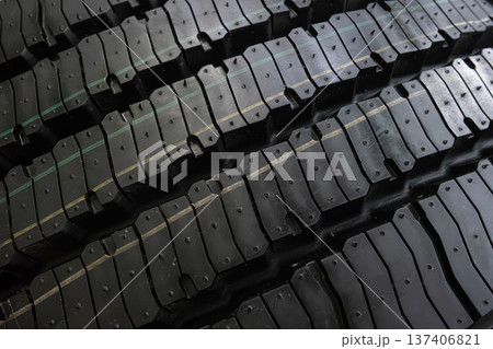 Black tire tread texture background with detailed rubber pattern. 137406821