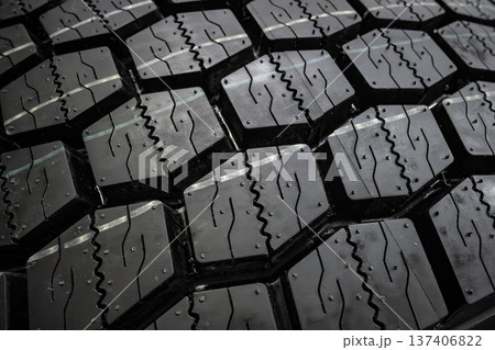 Black tire tread texture background with detailed rubber pattern. 137406822