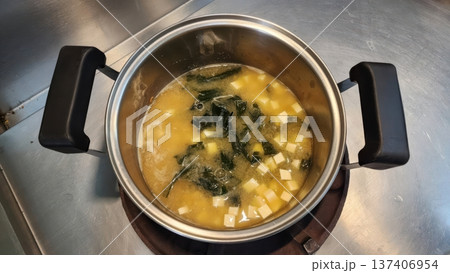 Traditional Japanese Miso Soup with Tofu and Seaweed Simmering in a Stainless Steel Pot Traditional Japanese Miso Soup with Tofu and Seaweed Simmering in a Stainless Steel Pot 137406954