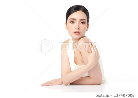 A beautiful young Asian woman with clean, fresh skin against a white background. Skincare, facial treatment, cosmetology, beauty, and spa. An elegant portrait of an Asian woman. A beautiful young Asian woman with clean, fresh skin against a white background. Skincare, facial treatment, cosmetology, beauty, and spa. An elegant portrait of an Asian woman. 137407009