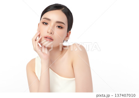 A beautiful young Asian woman with clean, fresh skin against a white background. Skincare, facial treatment, cosmetology, beauty, and spa. An elegant portrait of an Asian woman. A beautiful young Asian woman with clean, fresh skin against a white background. Skincare, facial treatment, cosmetology, beauty, and spa. An elegant portrait of an Asian woman. 137407010