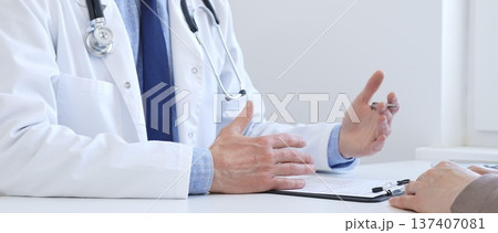 Doctor gesturing with hands while explaining diagnosis to patient during medical consultation in hospital office, healthcare and medical concept. Medicine 137407081