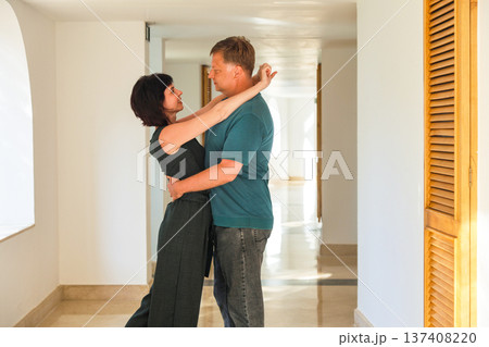 Romantic embrace of a loving adult couple in a hotel corridor, capturing the essence of intimacy and connection in a cozy, elegant setting Romantic embrace of a loving adult couple in a hotel corridor, capturing the essence of intimacy and connection in a cozy, elegant setting 137408220