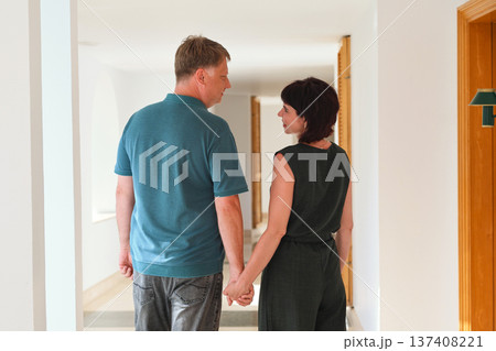 Romantic embrace of a loving adult couple in a hotel corridor, capturing the essence of intimacy and connection in a cozy, elegant setting Romantic embrace of a loving adult couple in a hotel corridor, capturing the essence of intimacy and connection in a cozy, elegant setting 137408221