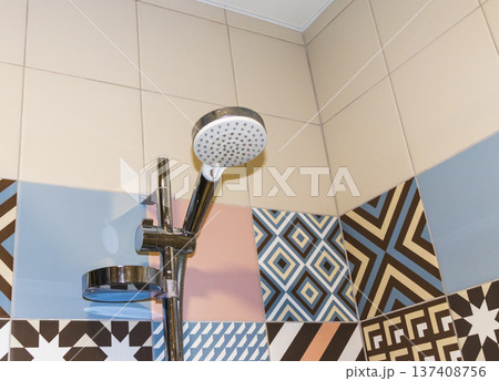 Shower set with running water, featuring a hand shower and a riser rail. 137408756