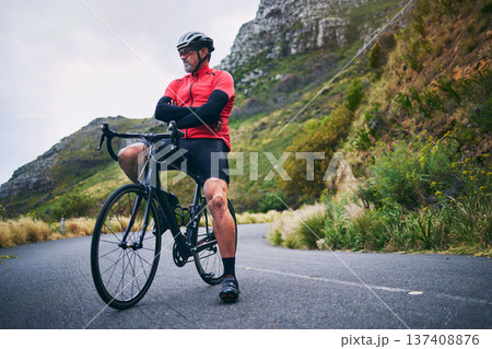 Fitness, cycling and thinking with man on bike in nature for sports, training and challenge. Exercise, workout and health with mature person on bicycle in mountains for energy, freedom or performance 137408876