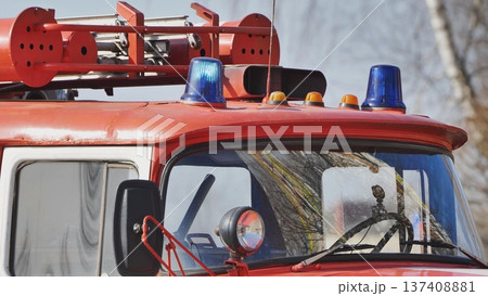 Flashing blue lights and orange signal lamps mounted on red fire truck roof Flashing blue lights and orange signal lamps mounted on red fire truck roof 137408881