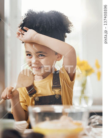Child in kitchen, baking with wooden spoon and cake flour on face, little baker making breakfast or cookies. Learning, cooking and happy boy chef in home with mixing bowl, tools and smile in morning. Child in kitchen, baking with wooden spoon and cake flour on face, little baker making breakfast or cookies. Learning, cooking and happy boy chef in home with mixing bowl, tools and smile in morning. 137408896