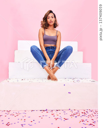Portrait, steps and woman with confetti, style and fashion with celebration on a pink studio background. Person, gen z or girl with sparkle, party or event with confident model or birthday decoration 137409059