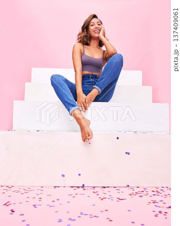 Happy woman, confetti and steps portrait with smile, style and fashion with celebration sparkle. Studio, pink background and female model with party and birthday decoration with gen z confidence 137409061