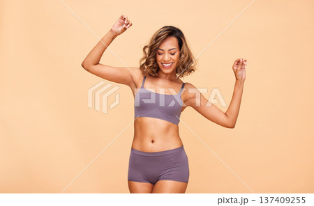 Self love, dance and happy woman in lingerie in studio with skincare, results and body positivity on wall background. Beauty, cosmetics and female model dancing for wellness, good mood or acceptance Self love, dance and happy woman in lingerie in studio with skincare, results and body positivity on wall background. Beauty, cosmetics and female model dancing for wellness, good mood or acceptance 137409255