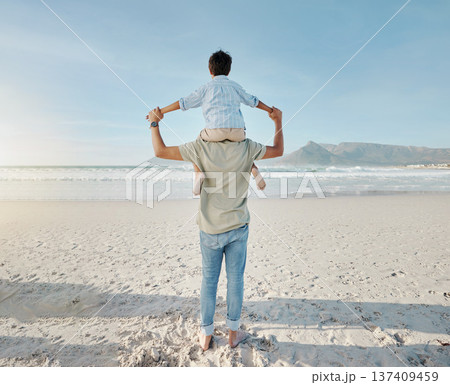 Dad, child on beach and piggy back together in summer waves on tropical island holiday in Hawaii. Fun, father and son on ocean vacation with love, support and relax at water with blue sky from back. Dad, child on beach and piggy back together in summer waves on tropical island holiday in Hawaii. Fun, father and son on ocean vacation with love, support and relax at water with blue sky from back. 137409459