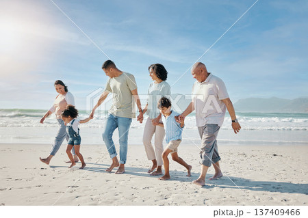 Family, holding hands and walking outdoor on a beach with love, care and happiness for summer vacation. Parents, grandparents or travel with men, women and children together for holiday adventure Family, holding hands and walking outdoor on a beach with love, care and happiness for summer vacation. Parents, grandparents or travel with men, women and children together for holiday adventure 137409466
