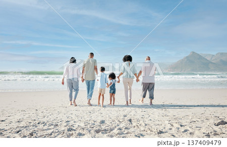 Family, holding hands and walking outdoor on a beach with love, care and happiness on summer vacation. Behind, space in sky or travel with men, women and children together for holiday adventure 137409479