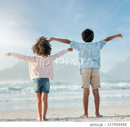 Kids, playing and airplane on beach, vacation or freedom on holiday in summer in Brazil with ocean, blue sky and happiness. Girl, boy and children play game as plane to fly for fun, bonding together 137409488