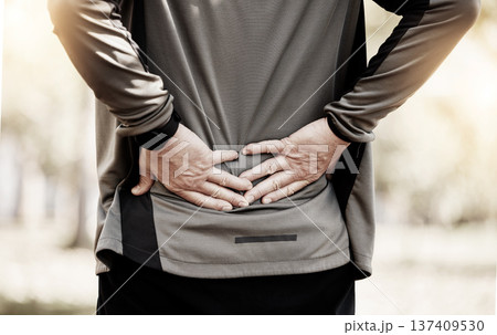 Runner, hands and back pain in park, injury or outdoor for fitness, training or muscle emergency. Person, spine accident and exercise for osteoporosis, fibromyalgia or arthritis in nature for workout Runner, hands and back pain in park, injury or outdoor for fitness, training or muscle emergency. Person, spine accident and exercise for osteoporosis, fibromyalgia or arthritis in nature for workout 137409530