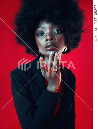 Black woman, portrait and afro, hair and beauty with makeup and shine isolated on red background. Hairstyle, haircare and texture with growth, face skin glow and confident African model in a studio Black woman, portrait and afro, hair and beauty with makeup and shine isolated on red background. Hairstyle, haircare and texture with growth, face skin glow and confident African model in a studio 137409868