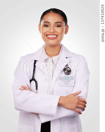 Portrait, doctor and smile of woman with arms crossed, confidence and pride in medicine and healthcare on white background. Medical worker, person and professional in studio with stethoscope Portrait, doctor and smile of woman with arms crossed, confidence and pride in medicine and healthcare on white background. Medical worker, person and professional in studio with stethoscope 137410029