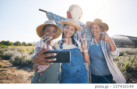Farmer, women peace sign and selfie in countryside with team and scarecrow outdoor with a smile. Diversity, worker group and happy with social media and profile picture on a agro farm and field Farmer, women peace sign and selfie in countryside with team and scarecrow outdoor with a smile. Diversity, worker group and happy with social media and profile picture on a agro farm and field 137410149